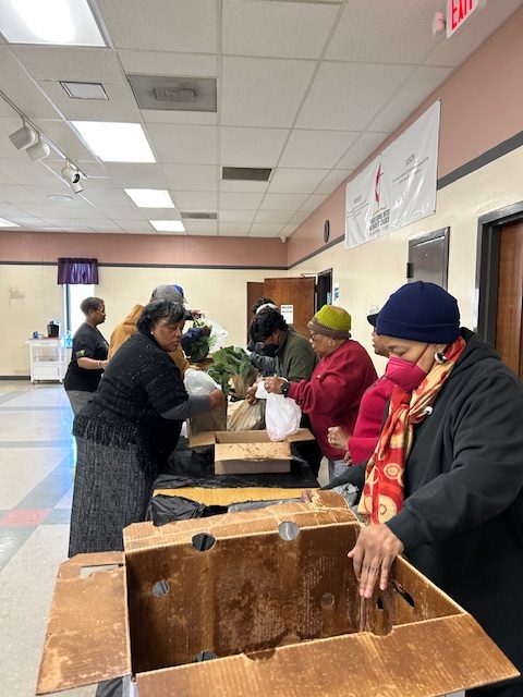 This image shows volunteers from the Burns Foundation feeding the community during their Food Farmacy