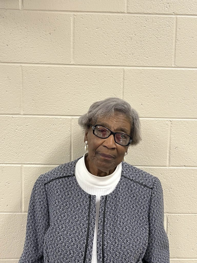 Image shows a picture of an older Black woman named Mrs. McNair with short grey hair and a black and white outfit on at Francis Burns United Methodist Church for their Mobile Mammography event held on November 11th, 2025.