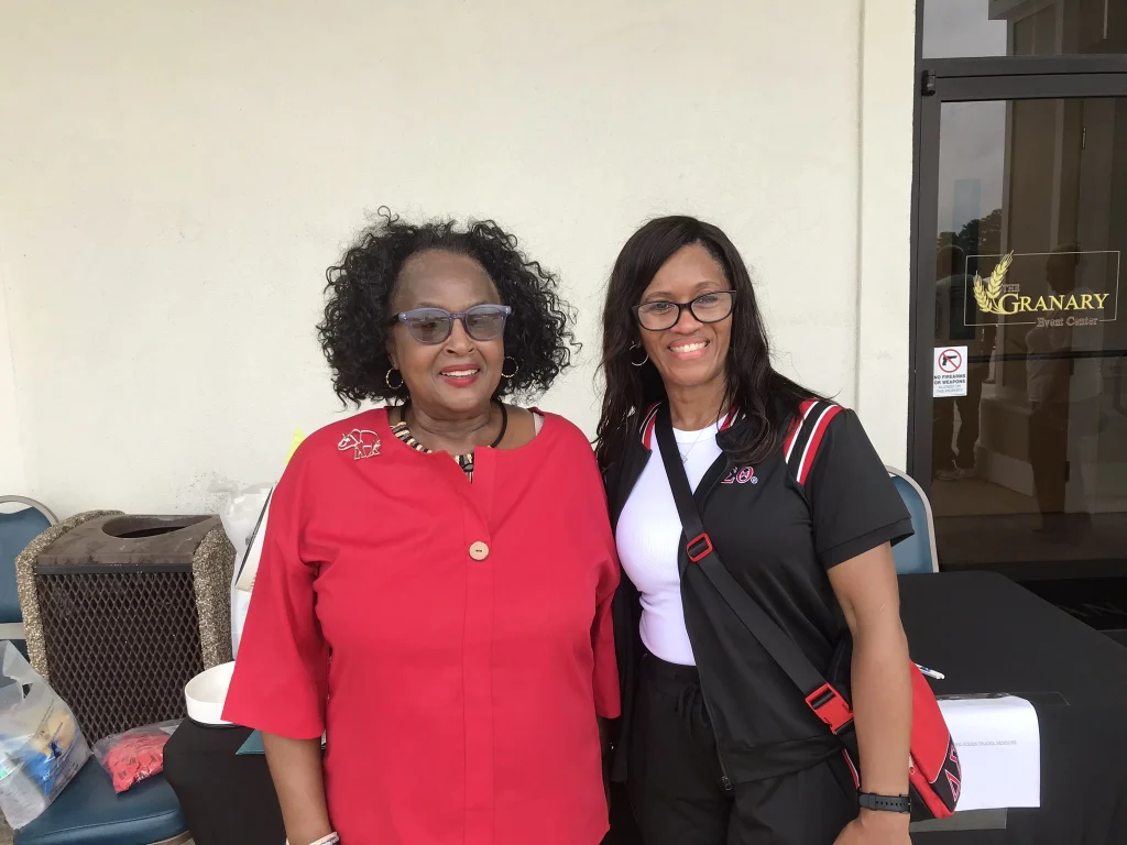 Two women attend a car show