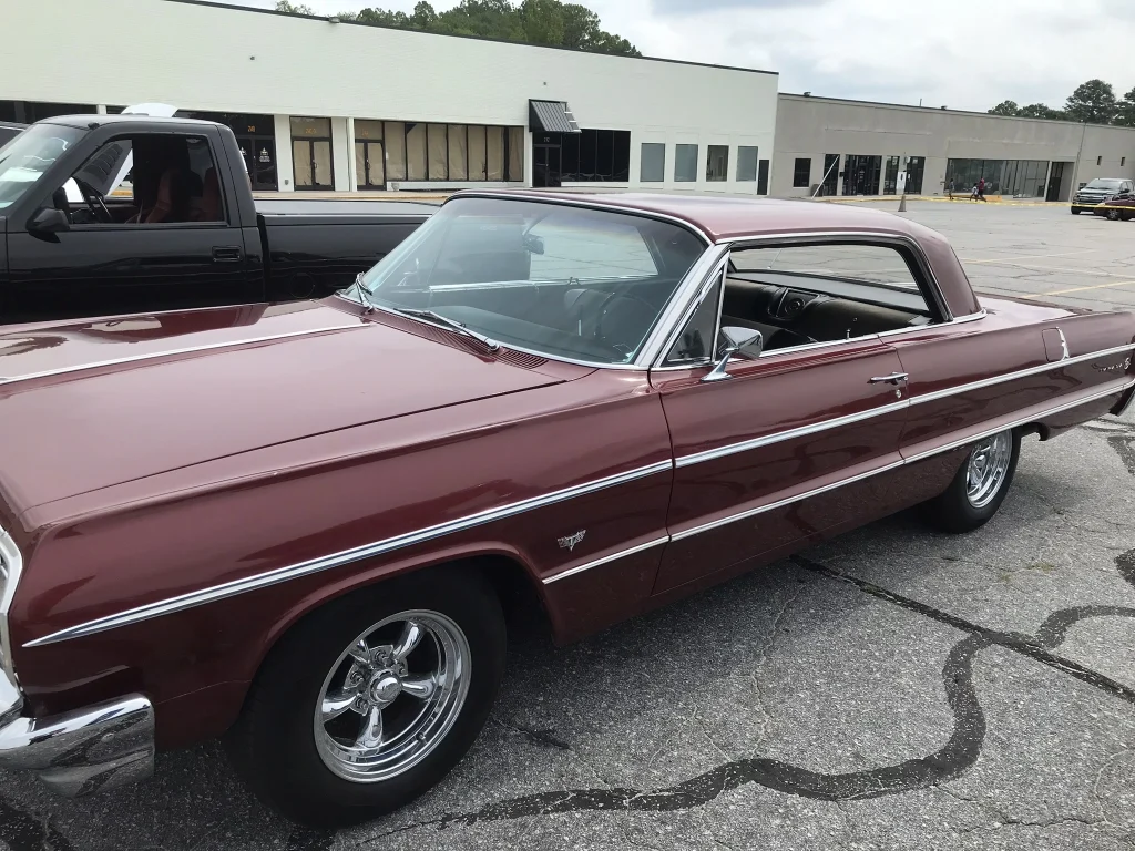 A burgundy colored classic car
